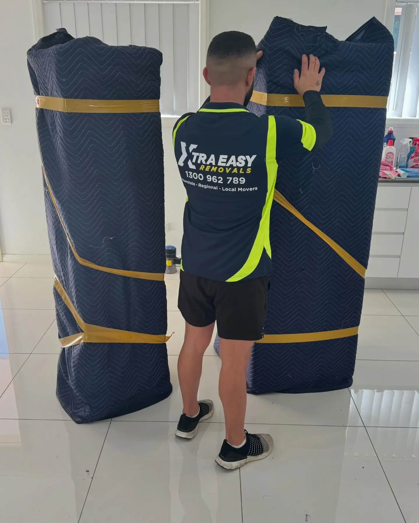 Expert removalists securing furniture for the Melbourne to Sydney interstate journey