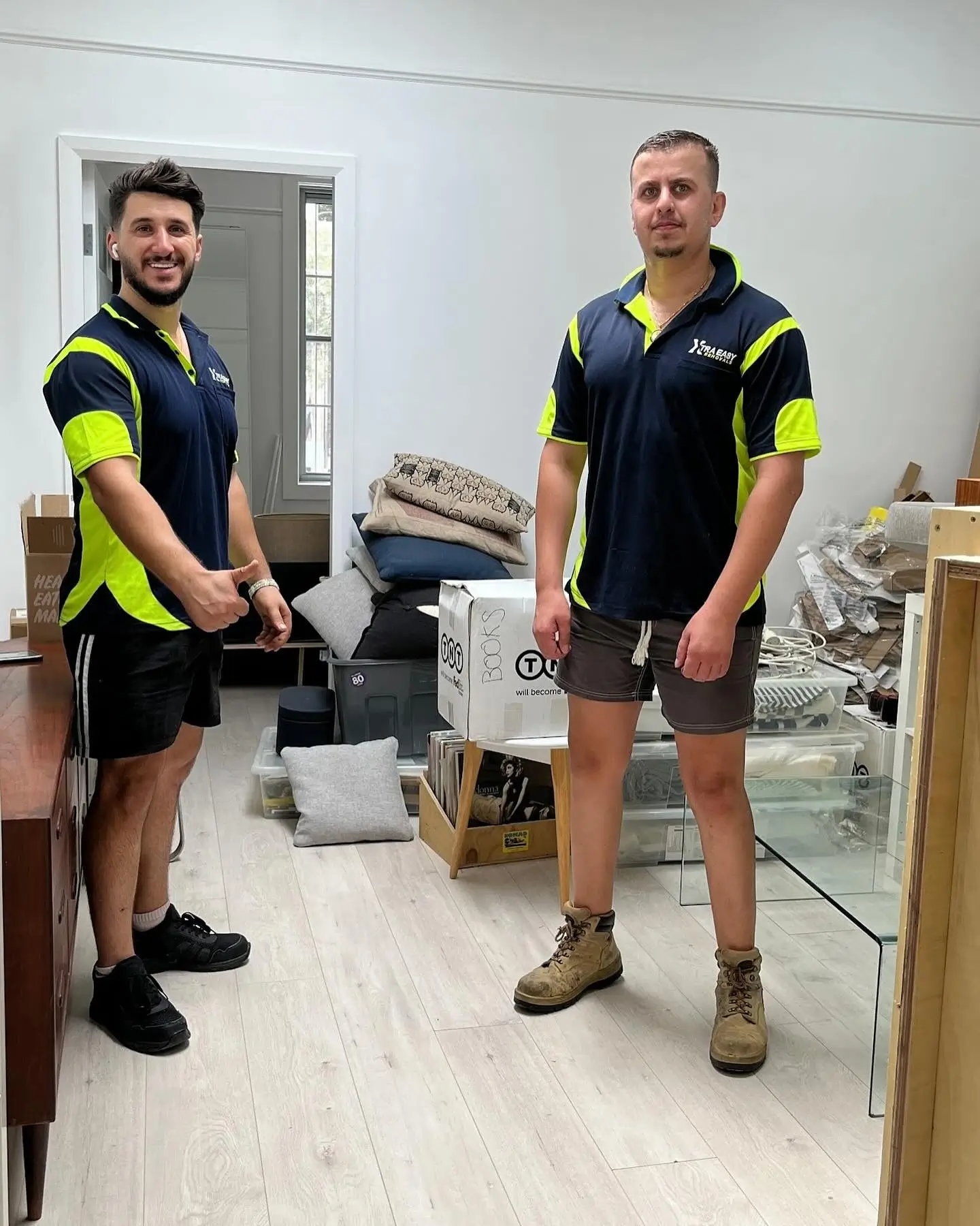 Local removalists Sydney team problem solving heavy table removal down a narrow stairwell 